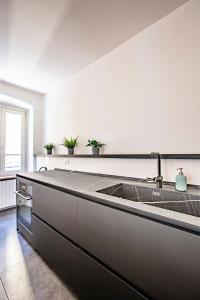 a kitchen with a sink and a counter at Lake Como with view, sauna and air conditioning in Mandello del Lario +32 photos
