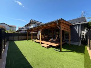 a backyard with a pavilion with green grass at テラスKawazu in Kawazu