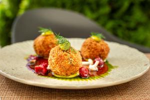 a plate of food with fruit on a table at Hotel Aqua Sopot - Destigo Hotels in Sopot +27 photos