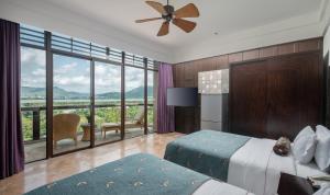 a bedroom with a bed and a large window at Yalong Bay Mangrove Tree Resort in Sanya