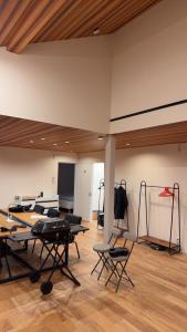 a room with tables and chairs in a room at テラスKawazu in Kawazu
