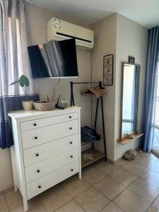 a white dresser with a tv on top of it at Studio Seaven, Lozenets in Lozenets