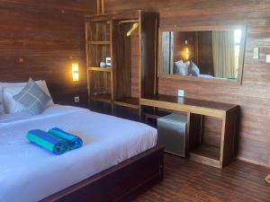 a bedroom with a bed with blue objects on it at Linda Beach Hotel in Nusa Lembongan +192 photos