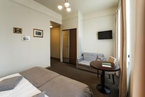 a hotel room with a bed and a table and a couch at Hotel Sigulda in Sigulda