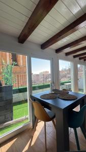 a dining room with a table and chairs and a window at Eirenè Peaceful Suites in Agrigento