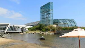 an umbrella in the water with a building in the background at ホテルテラス小名浜 in Iwaki