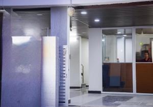 a building with a pillar in the middle of a hallway at NRI Hotels & Coliving in Hyderabad