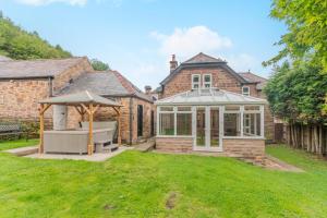 a house with a conservatory in the yard at 4 Bed in Matlock oc-52094 in Highpeak Junction