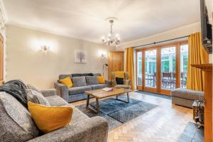 a living room with a couch and a table at 4 Bed in Matlock oc-52094 in Highpeak Junction