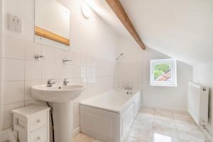 a white bathroom with a sink and a bath tub at 4 Bed in Matlock oc-52094 in Highpeak Junction +32 photos