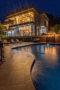 a large house with a swimming pool at night at LUX* Lake Kivu  +30 photos