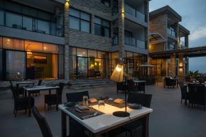 a restaurant with tables and chairs in front of a building at LUX* Lake Kivu 