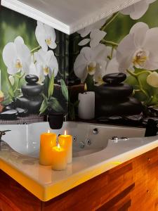 a bathroom with a bath tub with candles and flowers at PRIVADO HOTELS in Antalya +139 photos