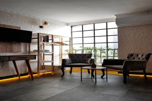 a living room with two chairs and a television at PRIVADO HOTELS in Antalya