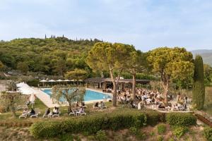 a crowd of people sitting around a pool at a resort at Residence San Michele in Costermano