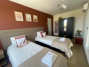 a hotel room with two beds in it at Villa Flandre in Berlare