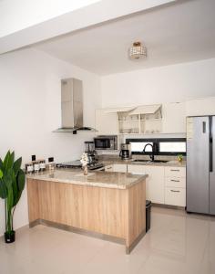 a kitchen with a large island in the middle at Luxurious Punta Cana House 3 Bedrooms, Shared Pool, BBQ in Punta Cana
