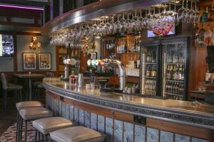 a bar with a counter with stools at Best Western Moores Central Hotel in St. Peter Port