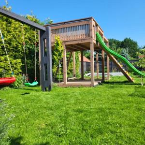 a playground with a slide in a yard at Apartamenty przy Skwerku in Sztutowo