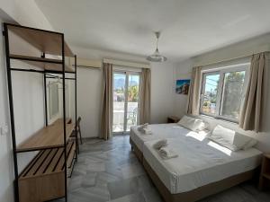 a bedroom with a bed and a book shelf at Kaloxenia in Kardamaina +62 photos