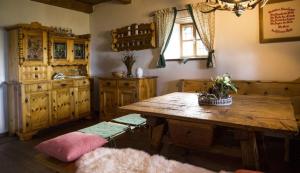 a kitchen with a wooden table and a table sidx sidx sidx sidx at Ferienhaus Staller Brendl in Sankt Georgen in Obdachegg