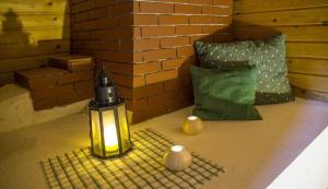 a lantern sitting on the floor next to a brick wall at Ferienhaus Staller Brendl in Sankt Georgen in Obdachegg