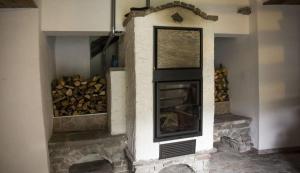 a fireplace with a pile of fire wood at Ferienhaus Staller Brendl in Sankt Georgen in Obdachegg +4 photos