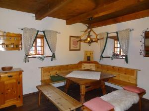 a dining room with a table and a bench at Ferienhaus Staller Brendl in Sankt Georgen in Obdachegg
