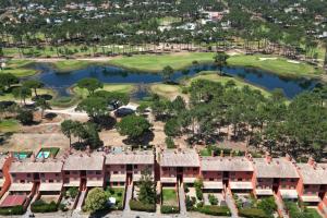 an aerial view of a resort with a golf course at bwelcome aroeira beach & golf in Charneca