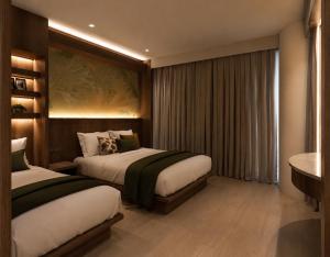 a hotel room with two beds and a table at Lokai Boutique Hotel in Dumaguete
