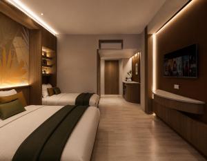 a hotel room with two beds and a television at Lokai Boutique Hotel in Dumaguete
