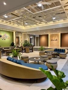 a lobby of a hotel with tables and chairs at Madigun Hotel and Events in San Francisco