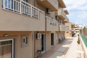 an empty alley between two buildings with balconies at Sunny Vibes by Estia Adults Only in Stalís