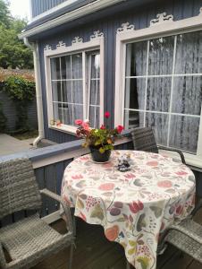 a table with a vase of flowers on a porch at Apartment Sonata in Jūrmala