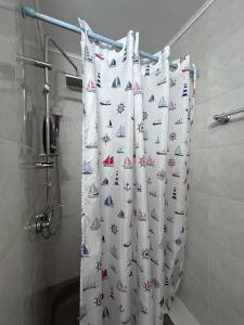 a shower curtain with boats on it in a bathroom at Chalet Rustique-Covasna in Covasna +52 photos