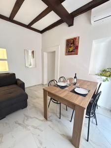 a living room with a wooden table and a couch at Domus Tarquinia in Tarquinia