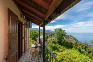 a balcony with a table and a view of the ocean at Adilon in Tsagarada