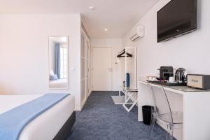 a hotel room with a bed and a kitchen at Miragaia - Riverside Suites - Adults Only in Porto +38 photos
