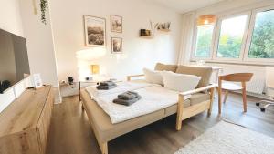 a living room with a couch and a table at happyhome mitten im HARZ - direkte Wanderwege - Bachplätschern - Küche - Kinderfreundlich - Paare und Freunde in Elend