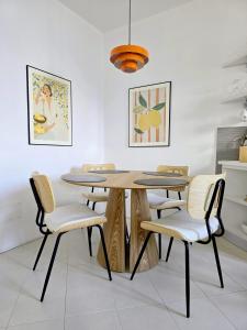 a dining room with a wooden table and chairs at IseoLakeRental - Collina Divina in Solto Collina