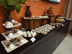 a buffet of desserts and pastries on a table at Crown Comfortia Hotel Jashore in Jessore +36 photos