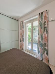 a bedroom with a bed and a window at IseoLakeRental - Collina Divina in Solto Collina