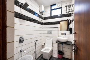 a bathroom with a toilet and a sink at Hotel Kamal Palace in Lucknow +16 photos