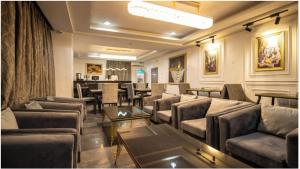 a living room with couches and a dining room at Vynedresa Hotel, Abuja in Abuja