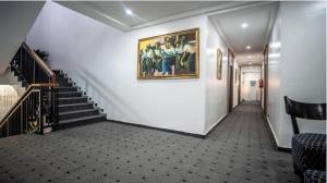 a hallway with stairs and a painting on the wall at Vynedresa Hotel, Abuja in Abuja