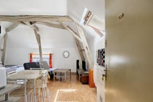 a kitchen and living room with a table and chairs at Studio 7 3 Min Du Futuroscope in Chasseneuil-du-Poitou