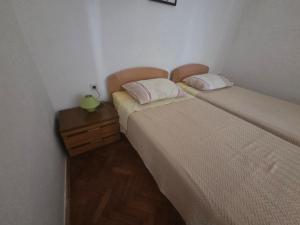 two beds sitting next to each other in a room at Apartment Boris in Labin