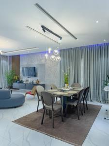 a dining room and living room with a table and chairs at Executive Cozy Suite at THE HIDDEN DOMUS I Saltpond Suite in Madina