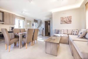 a living room with a couch and a table at Villa Thea in Triopetra