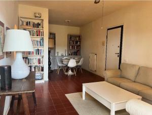 a living room with a couch and a table at Casa del Sole in Versilia in Cinquale